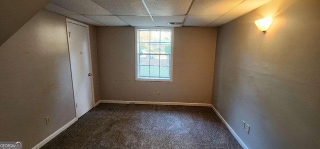 carpeted spare room with a drop ceiling