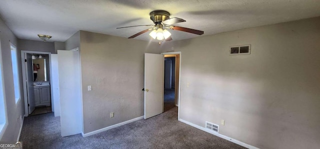 unfurnished bedroom with ceiling fan and carpet floors