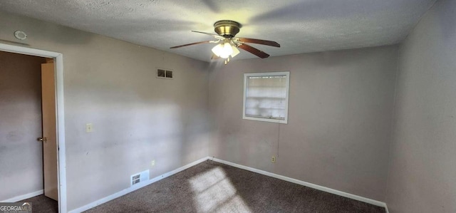 spare room featuring carpet flooring, ceiling fan, and a textured ceiling