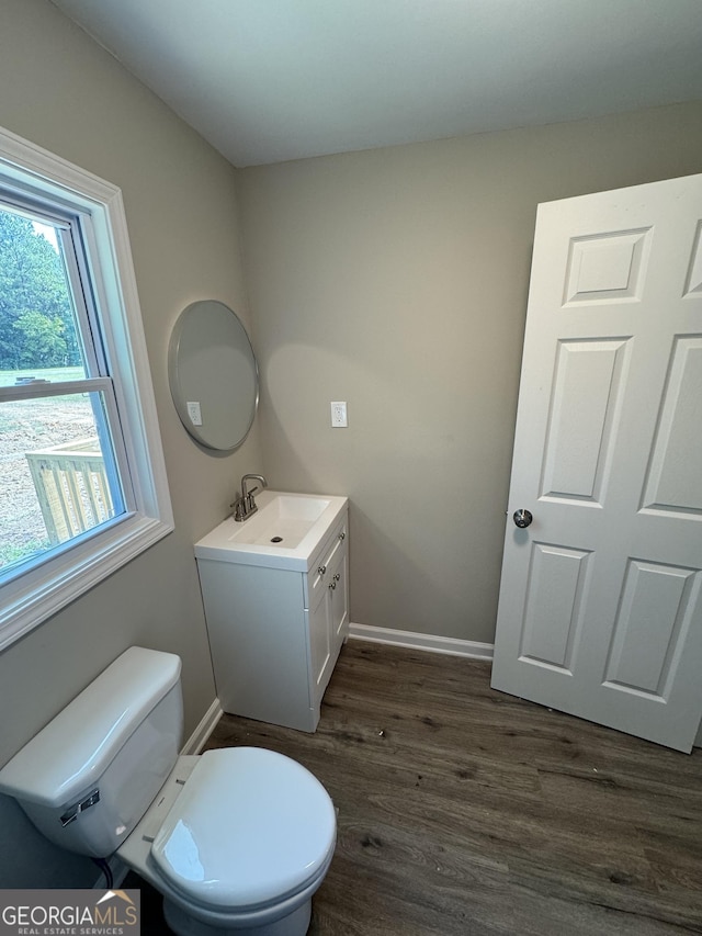 bathroom featuring vanity, hardwood / wood-style floors, and toilet