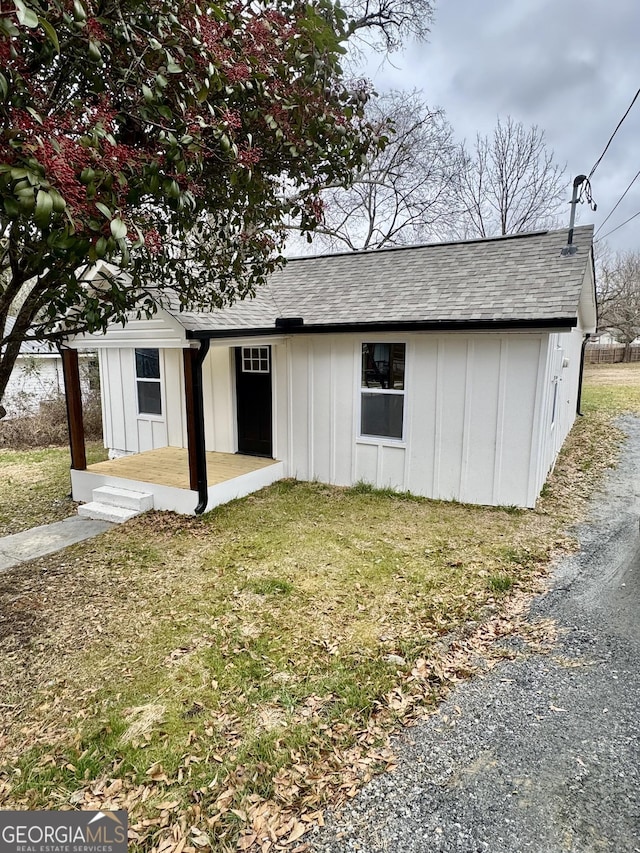 view of outbuilding with a yard