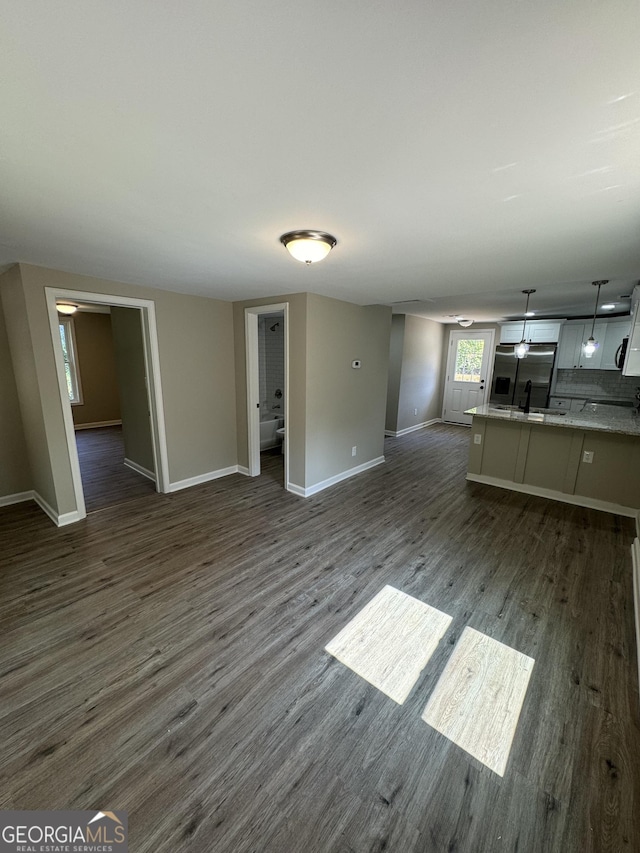 unfurnished living room featuring dark hardwood / wood-style flooring