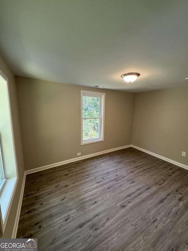 spare room featuring dark wood-type flooring