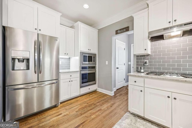 kitchen with backsplash, light hardwood / wood-style flooring, light stone countertops, white cabinetry, and stainless steel appliances