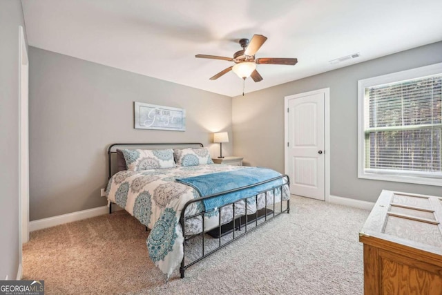 bedroom featuring light colored carpet and ceiling fan