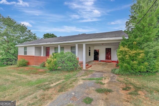 ranch-style house with a front yard and a carport