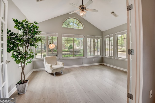 unfurnished room with ceiling fan, high vaulted ceiling, and light wood-type flooring