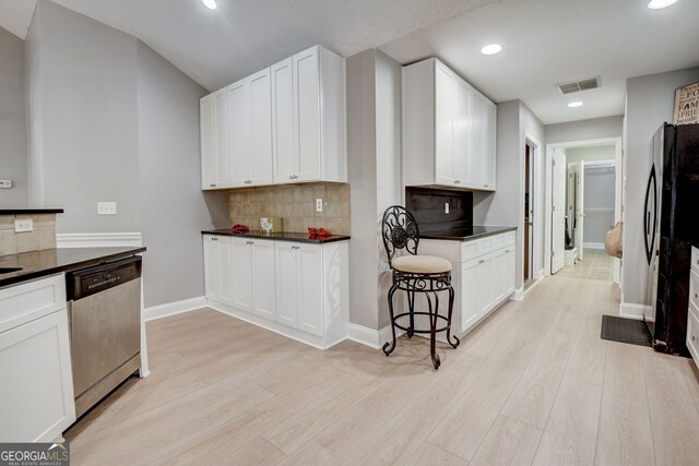 kitchen featuring dishwasher, white cabinets, refrigerator, decorative backsplash, and light hardwood / wood-style floors