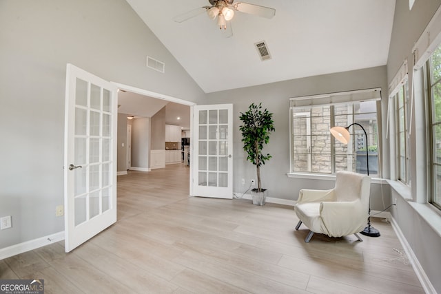 sitting room featuring french doors, high vaulted ceiling, light hardwood / wood-style flooring, and ceiling fan