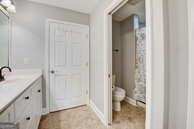 bathroom with tile patterned floors, vanity, and toilet