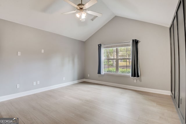 unfurnished bedroom with ceiling fan, light wood-type flooring, and lofted ceiling