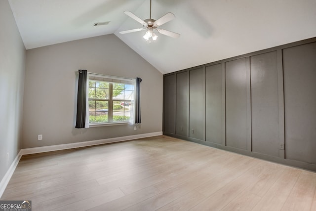 unfurnished bedroom featuring light hardwood / wood-style floors, ceiling fan, and lofted ceiling