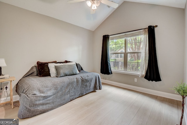 bedroom featuring hardwood / wood-style floors, ceiling fan, and lofted ceiling