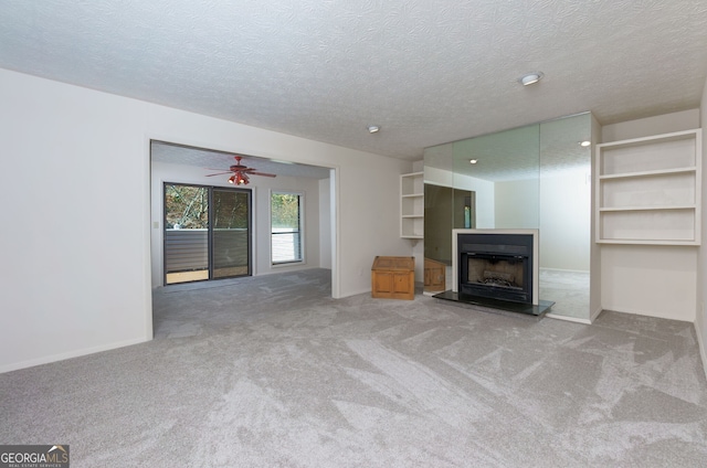 unfurnished living room with carpet and a textured ceiling