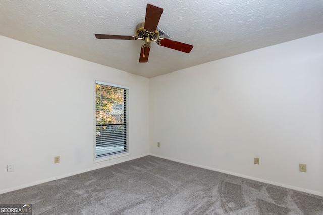 spare room featuring carpet, a textured ceiling, and ceiling fan