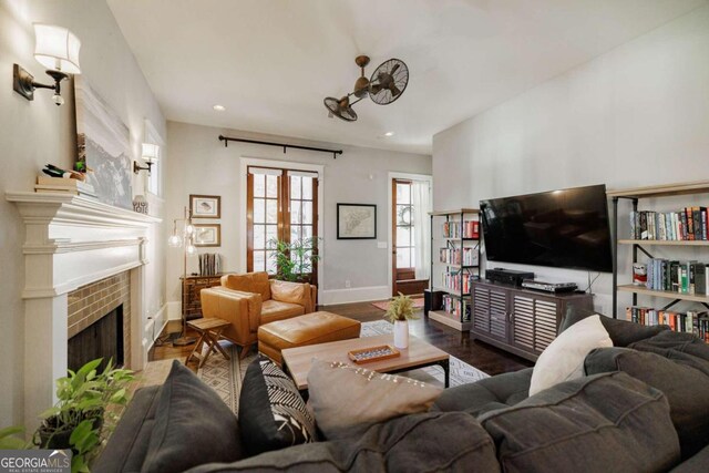 living room featuring a fireplace, dark hardwood / wood-style floors, and french doors