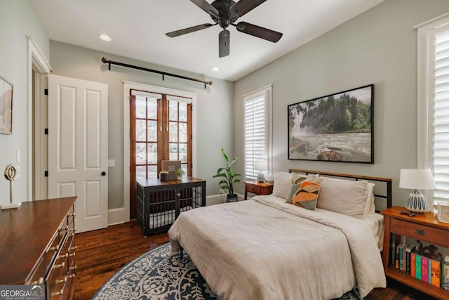 bedroom with ceiling fan, dark hardwood / wood-style flooring, and french doors