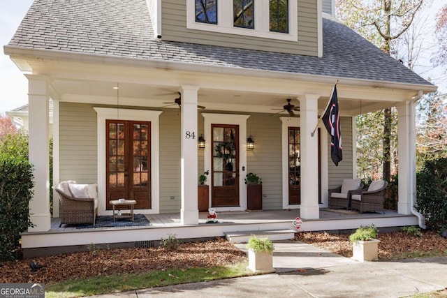 view of exterior entry with ceiling fan, french doors, and covered porch