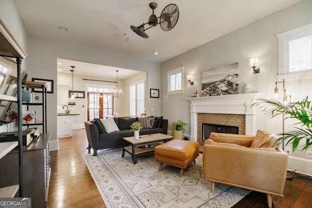 living room featuring french doors, a notable chandelier, and hardwood / wood-style flooring