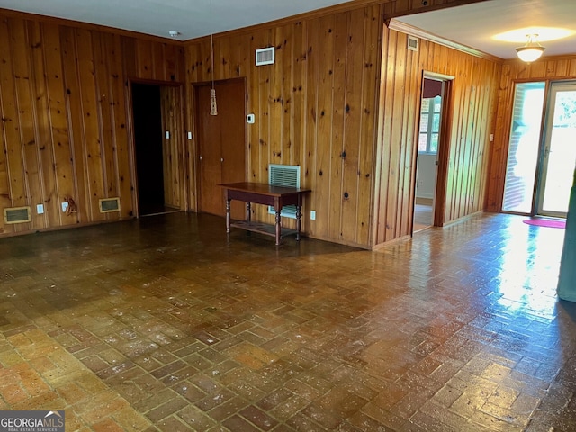 unfurnished room featuring wood walls