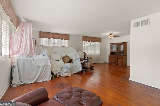 living room with plenty of natural light and dark hardwood / wood-style flooring