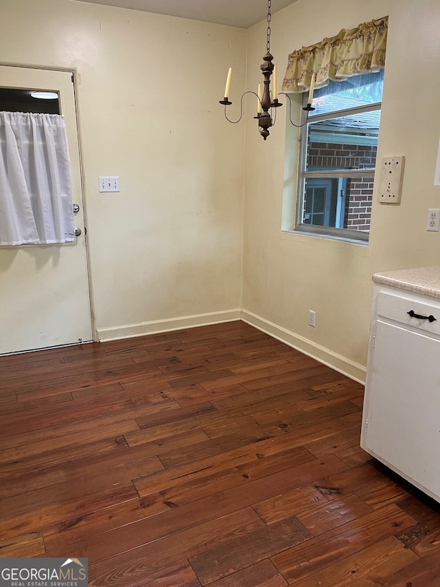 unfurnished dining area featuring dark hardwood / wood-style flooring