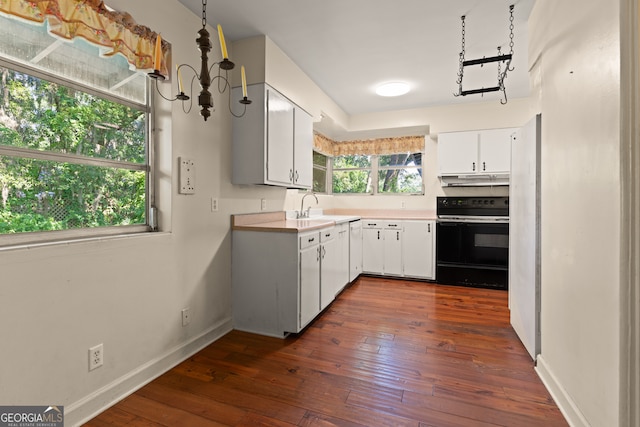 kitchen with white cabinetry, sink, dark hardwood / wood-style floors, black / electric stove, and a chandelier