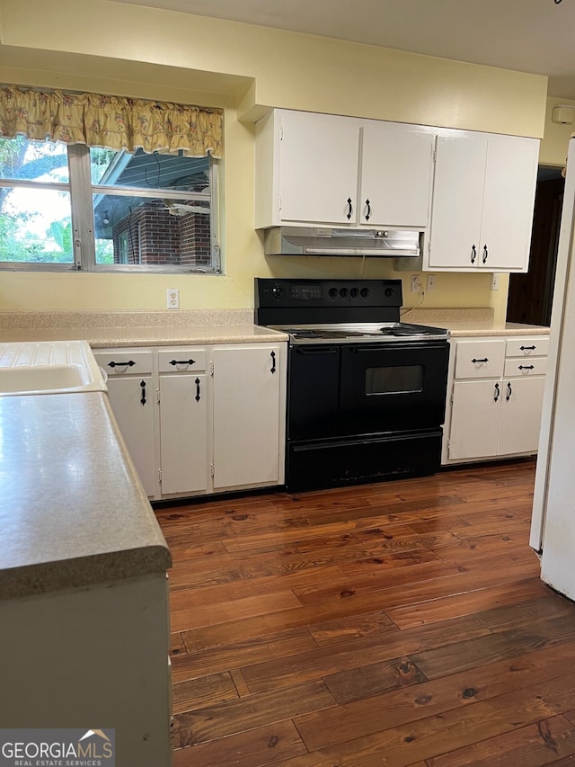 kitchen featuring black / electric stove, white cabinetry, dark wood-type flooring, and white refrigerator