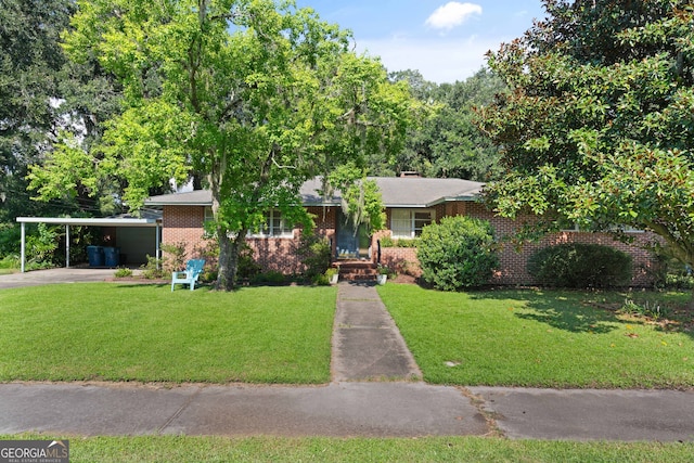 view of front of home with a front lawn and a carport