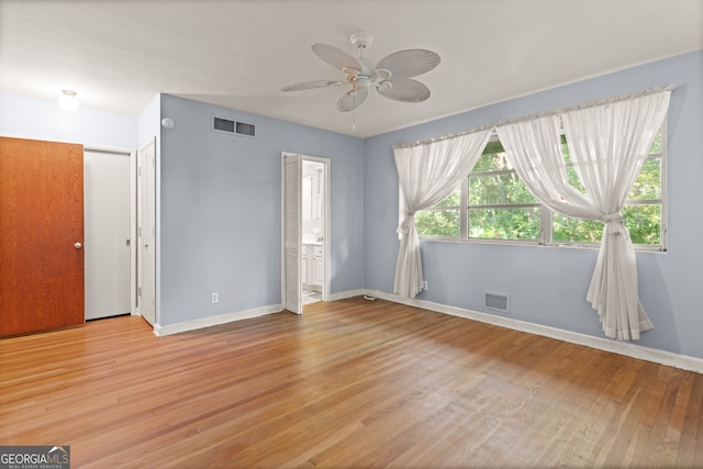 empty room with light hardwood / wood-style floors and ceiling fan