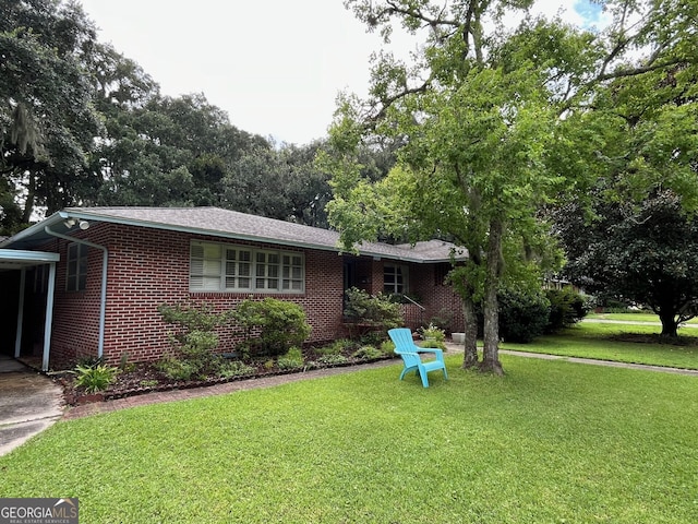 ranch-style house featuring a carport and a front lawn