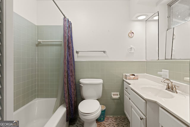 full bathroom with shower / bathtub combination with curtain, tile patterned floors, toilet, vanity, and tile walls