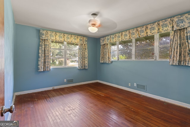 empty room with hardwood / wood-style floors and ceiling fan