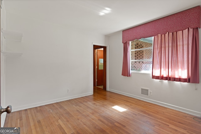 unfurnished room featuring light hardwood / wood-style floors