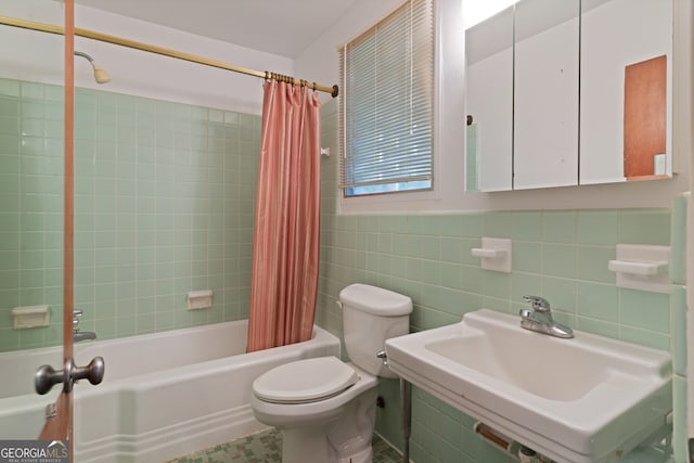 full bathroom featuring tile patterned floors, sink, toilet, shower / bathtub combination with curtain, and tile walls