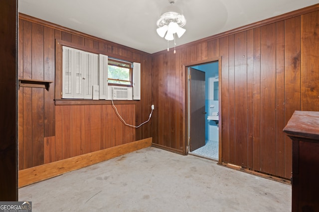 spare room with light colored carpet, ceiling fan, and wooden walls