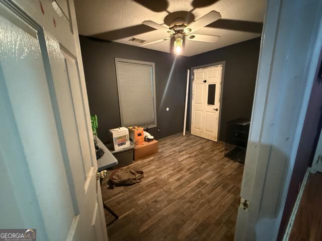 interior space featuring dark hardwood / wood-style flooring and ceiling fan