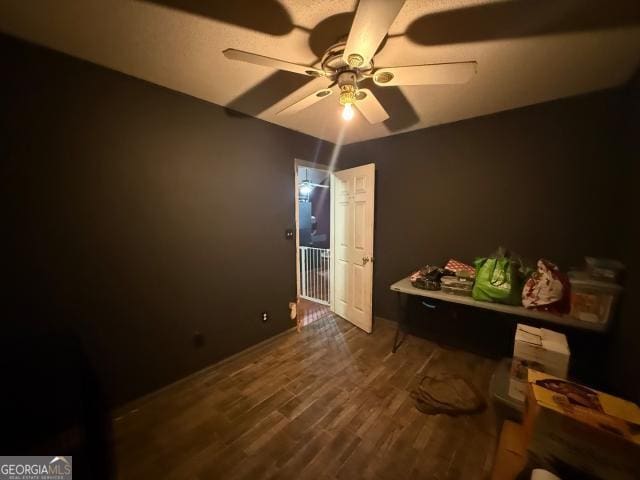 interior space with ceiling fan and dark hardwood / wood-style floors