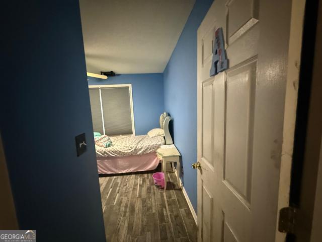 bedroom featuring ceiling fan and wood-type flooring