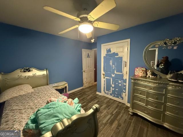 bedroom featuring ceiling fan and dark hardwood / wood-style floors