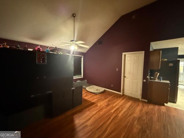 bedroom featuring hardwood / wood-style floors and high vaulted ceiling