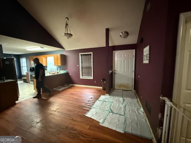 entrance foyer featuring light hardwood / wood-style flooring and vaulted ceiling