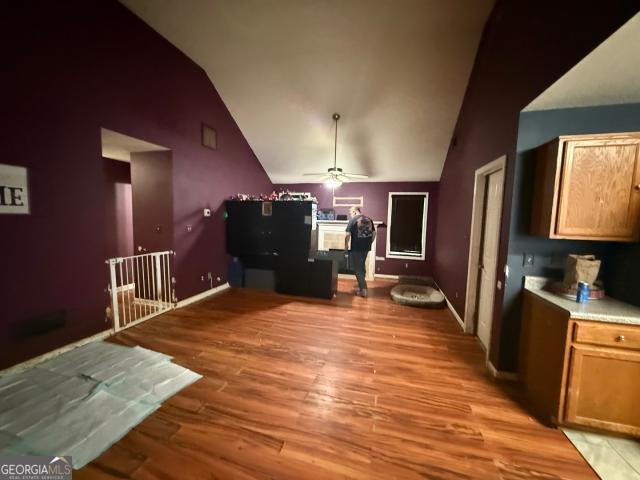 unfurnished dining area featuring high vaulted ceiling, light hardwood / wood-style flooring, and ceiling fan