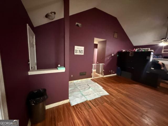 interior space featuring hardwood / wood-style flooring, vaulted ceiling, and ceiling fan