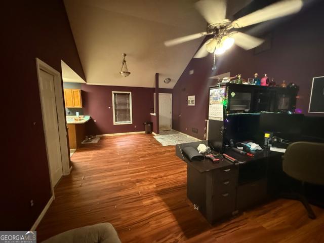 office space featuring hardwood / wood-style flooring, vaulted ceiling, and ceiling fan