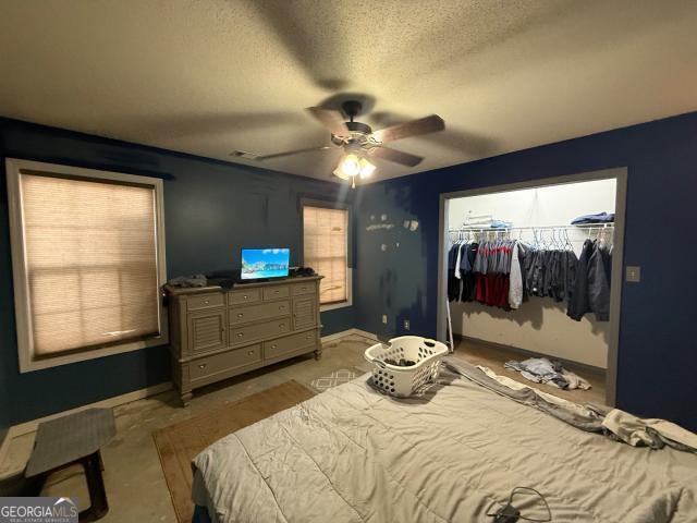 bedroom with a textured ceiling, a closet, and ceiling fan