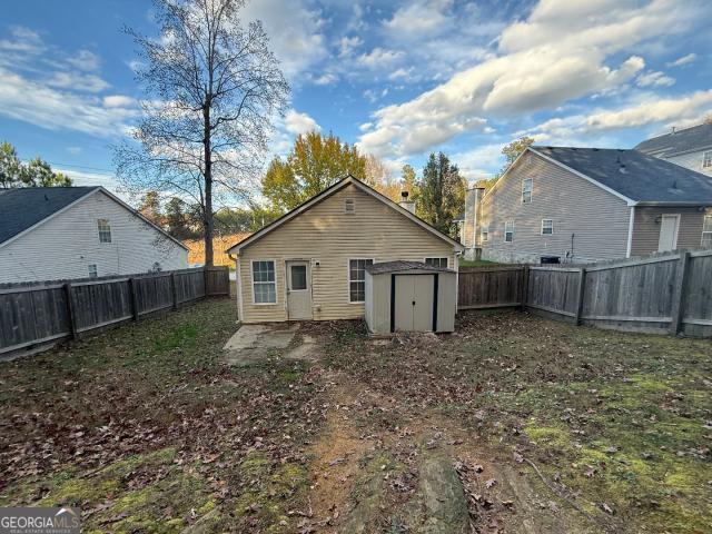 back of property with a storage unit