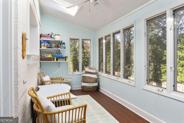 sunroom / solarium with lofted ceiling with skylight and ceiling fan