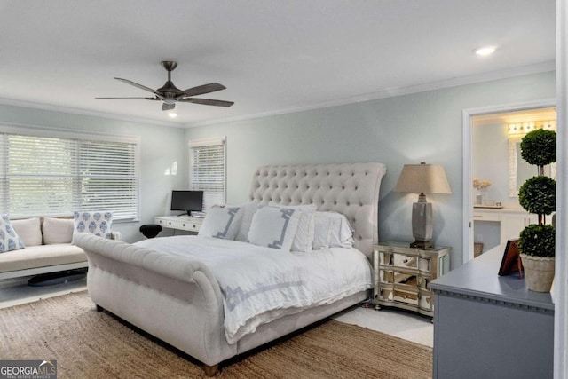 carpeted bedroom with ceiling fan, ornamental molding, and ensuite bath