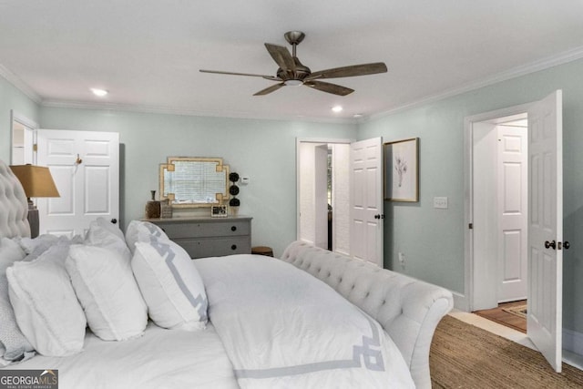 bedroom featuring hardwood / wood-style floors, ceiling fan, and ornamental molding